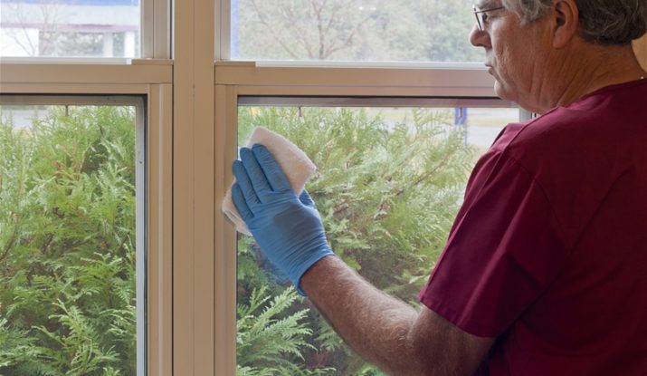 old man cleaning window