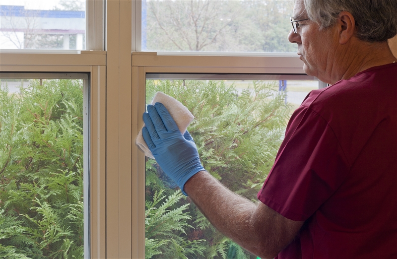 old man cleaning window